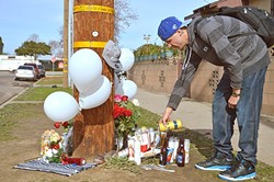 IN MEMORIAM:  Matt James, 24, pays his respects to Javier Murillo-Sanchez and Aaron Sanchez-Hernandez, 23-year-old cousins killed in Santa Maria on their way home from an Alcoholics Anonymous meeting on Jan. 13. - PHOTO BY DAVID MINSKY