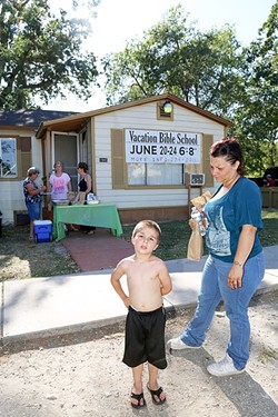 NUTRITION:  A mother, Cheryl, and her 4-year-old son, Zaden, pick up dinner at the People&rsquo;s Kitchen in Paso Robles before walking across the street to Pioneer Park. - PHOTOS BY DYLAN HONEA-BAUMANN