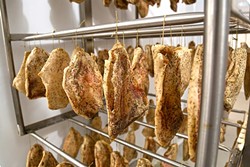 HANG ON:  Dozens of handmade guanciale (cured pork jowl) age to a graceful flavor. - PHOTO BY DYLAN HONEA-BAUMANN