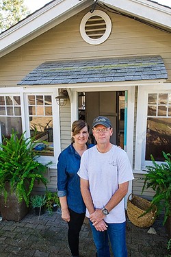 'NIGHTMARE':  Kathie and Steve Walker stand outside their home on Fredrick Street. The couple faces steep construction and permitting costs after an inspector found code violations. - PHOTO BY JAYSON MELLOM