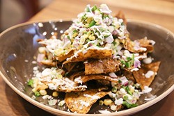 LIKE NO OTHER:  Nachos are elevated by rich duck meat and sharp, crumbly feta cheese. - PHOTO BY DYLAN HONEA-BAUMANN