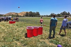 BROS WILL BE BROS:   The 2017 California Beer Festival, held May 27 in the Madonna Inn meadow, brought out a huge crowd of college kids, some of whom played giant beer pong. - PHOTO BY GLEN STARKEY