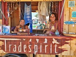 SPIRIT QUEENS Tradespirit Mobile Boutique proprietor Jen Chen (left) and her friend and co-worker Azere Wilson helm their adorable vendor trailer, vowing to return to Live Oak next year. - PHOTO BY GLEN STARKEY