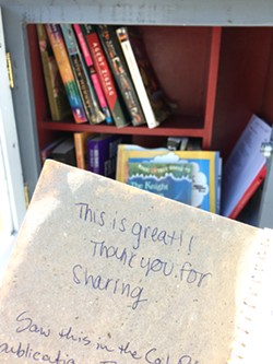 COMMENTS Some little libraries have comment books where borrowers can write about their experience of stumbling upon the little box on a walk around the neighborhood. - PHOTO BY KAREN GARCIA