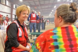 LENDING AN EAR Longtime Red Cross volunteer Carolyn Pandol listens to shelter resident Michelle Mullin tell the story of how she escaped from the Thomas Fire. - PHOTO BY DERMOT TATLOW COURTESY OF THE RED CROSS