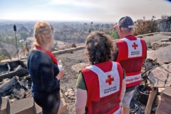 GONE Linda Allen stands with Red Cross volunteers as she looks at the remainder of her home in Ventura's Skyline neighborhood. - PHOTO BY DERMOT TATLOW COURTESY OF THE RED CROSS