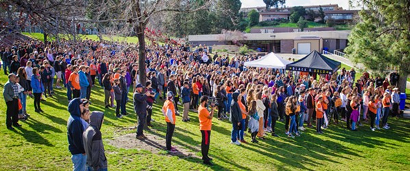 ENOUGH Students gathered on the lawn at San Luis Obispo High School during the March 14 student walkout to protest gun violence on school campuses and honor the 17 victims who were shot in Parkland, Florida, on Feb. 14. - PHOTO BY JAYSON MELLOM