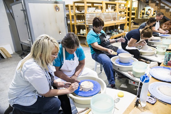 LEARN Susan Bass, owner of Pottery Coast in Grover Beach, teaches a student how to properly use the potter’s wheel during a class. - PHOTO BY JAYSON MELLOM