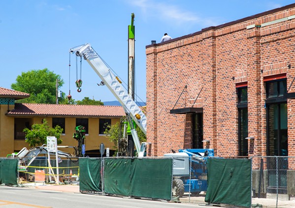 UNDER DEVELOPMENT Cranes, such as this one at a project on Santa Rosa Street, have been visible at sites all over San Luis Obispo, pointing to an economic upswing and commercial/residential development. - PHOTO BY JAYSON MELLOM