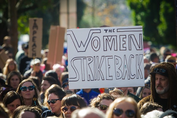 BACK IN THE STREETS A sign from the 2017 Women's March in SLO. On Sept. 26, the march's organizers held a rally in support of sexual assault victims, many of whom do not report their attacks. - FILE PHOTO BY JAYSON MELLOM