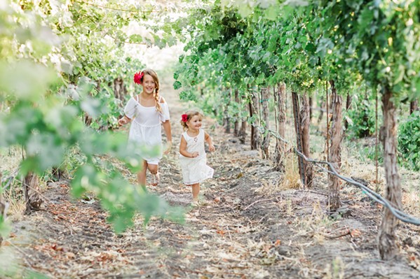 SHOOT FOR THE STARS Macoy Sill and Cecilia Higgins frolic in the vines. When little girls are asked what they want to be when they grow up, Dream Big Darling founder and CEO Amanda Wittstrom-Higgins wants careers like "vineyard manager" and "wine sales rep" to spring to mind. - PHOTO COURTESY OF DREAM BIG DARLING
