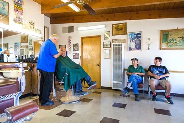 BUZZING CONVERSATION At 85 years old, Phillips is cutting hair and listening to the people of Atascadero who sit in his seat until 5 p.m. - PHOTO BY JAYSON MELLOM