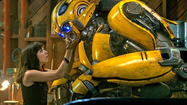 DYNAMIC DUO Charlie (Hailee Steinfeld) befriends Bumblebee, an Autobot disguised as a VW Beetle in a junkyard, in the Transformers prequel Bumblebee. - PHOTO COURTESY OF ALLSPARK PICTURES