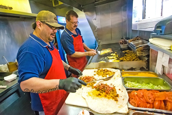 BURRITOS UP (Left to right) Jesus Rivera and Carlos Cortes bust out the best BREAKFAST burritos in the county at Frank’s Famous Hot Dogs. Don’t forget, the dogs are good, too. - PHOTO BY JAYSON MELLOM