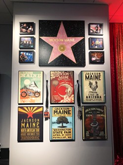ALL YOU GOTTA DO IS TRUST ME Props from A Star Is Born (2018), including Jackson Maine's (Bradley Cooper) Hollywood Walk of Fame Star and fake concert posters, adorn a wall in the Script to Screen display. - PHOTOS BY GLEN STARKEY