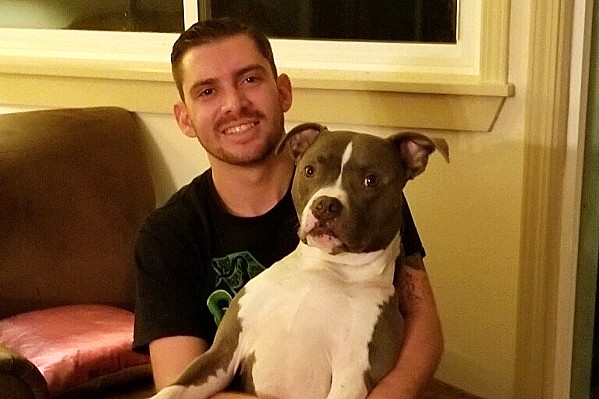 DEADLY SHOOTING Bubbs, a 7-year-old pit bull-boxer mix, was shot and killed by a SLO police officer on Sept. 26. His owners, Nick Regalia (pictured) and Riley Manford, plan to sue the city in response. - PHOTO COURTESY OF NICK REGALIA
