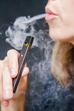 UNDER FIRE SLO County resident Nick Limpangug is suing Juul because of what he claims are "severe personal injuries" sustained while using the company's e-cigarettes. - FILE PHOTO BY JAYSON MELLOM