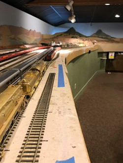 MODEL A model railway sits in the SLO Railroad Museum. Pictured is the train station in SLO&mdash;note Bishop Peak and Cerro San Luis in the background. - PHOTOS BY PETER JOHNSON