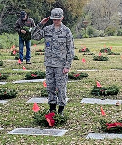 APPRECIATION During a Dec. 14 ceremony, Coni Wells watched her 13-year-old son Colton place wreaths on graves and salute veterans who were laid to rest in the Paso Robles District Cemetery. - PHOTO COURTESY OF CONI WELLS
