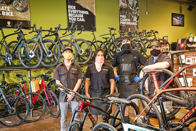 BUY THAT BIKE Left to right: Brad Wiggs, Dustin Stiffler, Adam Jacino, and Josh Cohen at Foothill Cyclery in SLO are ready to outfit you with new gear and help you troubleshoot your bike problems from a safe distance. - PHOTO BY JAYSON MELLOM