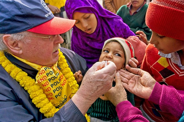 LIFE SAVER An American Rotarian delivers two oral drops of polio vaccine to an Indian child in local filmmakers Eriksen and Soren Dickens' documentary, Two Magic Drops, available for free on YouTube. - PHOTOS COURTESY OF LAURIE EDWARDS