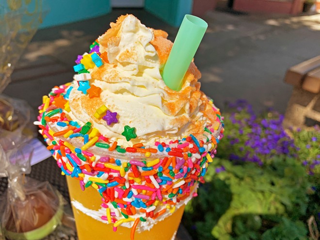 'STARTER SODA' The Pacific Sunrise is a mix of orange juice, passionfruit and peach purees, and soda water topped with housemade whipped cream, sprinkles, and candy powder.