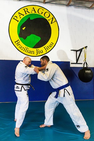 SPAR IT OUT Paragon Brazilian Jiu Jitzu instructor Jon Green (left) tangles with J.T. Lyon at the Best Martial Arts Studio, which has locations in SLO, Atascadero, Arroyo Grande, and Paso Robles. - PHOTO BY JAYSON MELLOM