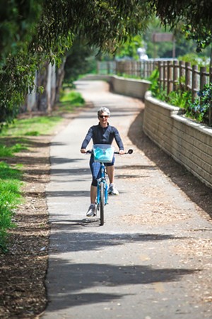 RIDE ON Melissa Trinidad goes for a spin on the best bike trail in the county—yes, it’s always been that paved path that takes riders from city to sea: The Bob Jones Trail. - PHOTO BY JAYSON MELLOM