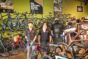 BUY THAT BIKE Left to right: Brad Wiggs, Dustin Stiffler, Adam Jacino, and Josh Cohen at Foothill Cyclery in SLO are ready to outfit you with new gear and help you troubleshoot your bike problems from a safe distance. - PHOTO BY JAYSON MELLOM