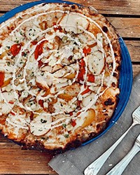 PIZZA OF THE WEEK Earth and Oven's oak grilled jerk chicken pizza (pictured) with Cali-Caribbean sauce, bell peppers, pineapple salsa, and jerk cr&egrave;me fra&icirc;che was the special pizza for the first week of September. The special changes each week.