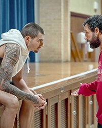 GOLDEN TICKET Basketball scout Stanley Sugerman (Adam Sandler, right) wants to get off the road and start coaching, but to do that he'll first need to train Spanish streetballer Bo Cruz (Juancho Hernangomez) into a viable NBA star, in Hustle, streaming on Netflix.