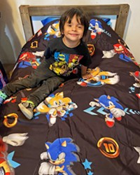 NEW COMFORT A child enjoys his new bed built and delivered by Sleep in Heavenly Peace Santa Barbara County North volunteers. The organization has its sights set on expanding into SLO County to help families in need of beds for children ages 3 to 17.