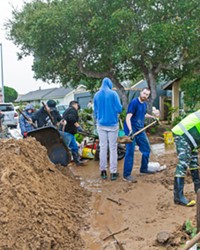 COMMUNITY HELP Hundreds of volunteers in Los Osos gathered to help residents on Vista Court dig out their homes from a mudslide caused when stormwater pushed through a Los Osos Community Services District water basin levee on Jan. 9.