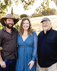 FAMILY IS EVERYTHING "There is something beautiful about being surrounded by people you love when you're at work," says Bella Luna General Manager Nichole Healey-Finn, center. Her father, Kevin Healey, right, co-founder of the winery, oversees the vineyard, while her husband, Lukas Finn, left, is head winemaker.