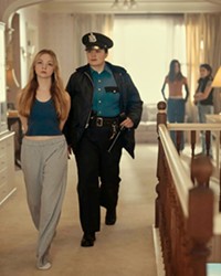 TROUBLED TEENS Investigator Cam Bentland (Lily Gladstone) questions Josephine Bell (Chloe Guidry) and other kids from a group home about a missing and possibly murdered teen, in Under the Bridge, on Hulu.