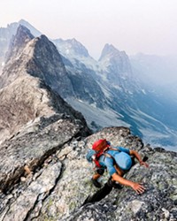 HANG ON Andrew Okerlund scrambles up East Mox, one of the peaks on The Bulger List.