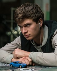 GO, BABY, GO! In Baby Driver, a young getaway driver (Ansel Elgort) is forced to work for a crime boss (Kevin Spacey).