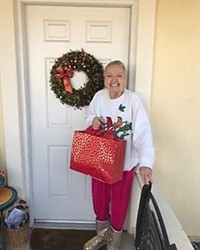 SPREADING JOY Dressed to impress in her holiday gear, Eden received a gift from the Be a Santa to a Senior program.