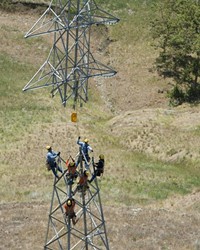 COMMUNITY ENERGY PG&E crews work on a local transmission line in 2013. A Community Choice Energy program pursued by SLO would use existing infrastructure to distribute power.