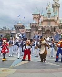 THE GANG'S ALL HERE Mickey, Minnie, Donald, Goofy, Pluto, Chip, and Dale dance their tails off in front of the Sleeping Beauty Castle.