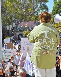READY TO RALLY Gina Whitaker (left) and Alex Lancaster address a 1,500-strong crowd in front of the SLO County courthouse at a June 30 protest against the separation of undocumented immigrant children from their families by the Trump administration.