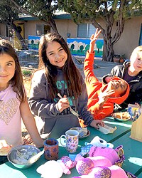 FOOD AND FUN Santa Lucia School students enjoy their lunch and play outside.