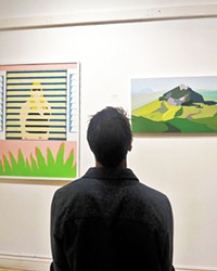 FAMILIAR SIGHTS A gallerygoer observes a featured painting that captures San Luis Obispo's iconic mountains.
