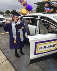 HATS OFF A Righetti High School student receives their diploma before hopping back in the car with their supporters.