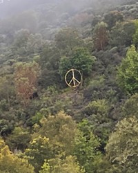 SHINING BRIGHT As they go over the Cuesta Grade, drivers on Highway 101 can see Lyle Nighswonger's peace sign made from an old satellite dish.