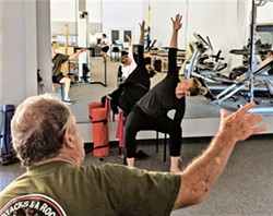 PHOTO COURTESY OF PRECISION PHYSICAL THERAPY - HEALTHY MOVEMENT Dr. Kristen Carless works with a client during one of her twice-a-week Parkinson's Wellness Recovery classes at Precision Physical Therapy in SLO.